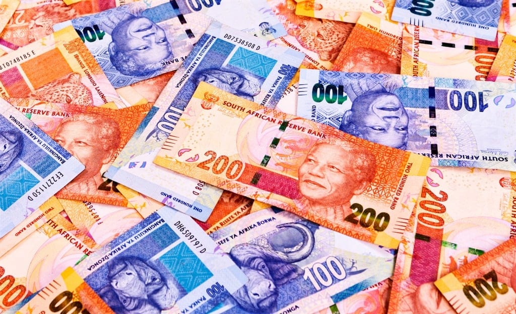 A pile of colorful South African banknotes in various denominations, featuring wildlife illustrations and a portrait. The bills range from 10 to 200 Rand, displaying vibrant designs and colors.